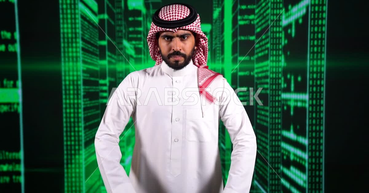 A young Saudi Gulf Arab working as a web developer, using a variety of ...