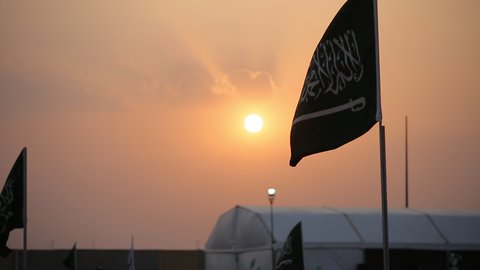 The flag of the Kingdom of Saudi Arabia at sunset, the banner of monotheism and Islam and the emblem of national identity, the concept of love of the homeland and belonging to it, loyalty and allegiance to the country, celebrating national occasions and holidays, the anniversary of the National Day on September 23, Flag Day on March 11