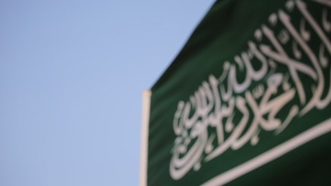 Distinctive air shows at the National Day Air Show on September 23, national occasions and celebrations, close-up of the Saudi flag in front of aircraft flying in the skies of the Kingdom of Saudi Arabia, Flag Day on March 11, expressing love and loyalty to the country