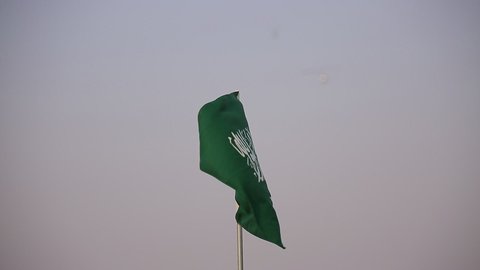 Distinctive air shows at the National Day Air Show on September 23, national occasions and celebrations, close-up of the Saudi flag in front of aircraft flying in the skies of the Kingdom of Saudi Arabia, Flag Day on March 11, expressing love and loyalty to the country