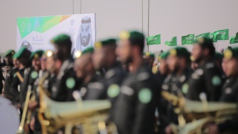 Raising the flags of the Kingdom of Saudi Arabia, the banner of monotheism and Islam and the slogan of national identity, Saudi citizens celebrating on the road, the concept of love of the homeland and belonging to it, loyalty and allegiance to the country, celebrating national occasions and holidays, the anniversary of the National Day on September 23, Flag Day on March 11