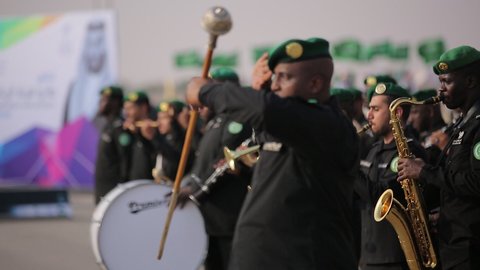 Raising the flags of the Kingdom of Saudi Arabia, the banner of monotheism and Islam and the slogan of national identity, Saudi citizens celebrating on the road, the concept of love of the homeland and belonging to it, loyalty and allegiance to the country, celebrating national occasions and holidays, the anniversary of the National Day on September 23, Flag Day on March 11