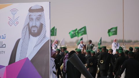 Raising the flags of the Kingdom of Saudi Arabia, the banner of monotheism and Islam and the slogan of national identity, Saudi citizens celebrating on the road, the concept of love of the homeland and belonging to it, loyalty and allegiance to the country, celebrating national occasions and holidays, the anniversary of the National Day on September 23, Flag Day on March 11