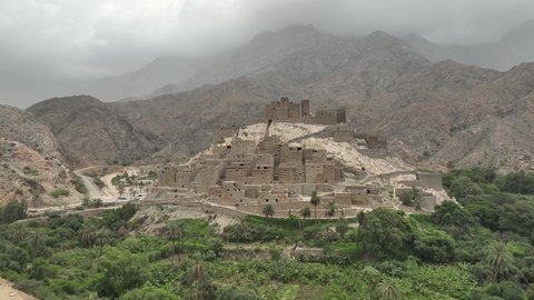 البيوت الطينية القديمة في قرية ذي العين التراثية, نمو النباتات في القمم والمرتفعات الجبلية, جبال منطقة الباحة, معلم سياحي طبيعي مشهور في المملكة العربية السعودية, التكوينات والتشكيلات الصخرية