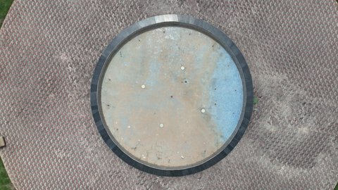 Green trees and plants in one of the parks in Al Baha region, green nature in the mountain peaks and heights, car traffic in the streets and roads surrounding the park, famous tourist places and landmarks in Saudi Arabia