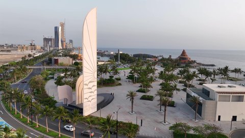 Famous roads and landmarks on the Corniche overlooking the Red Sea, an aerial view of Al-Nawras Square in Jeddah, Saudi Arabia, modern architectural design, and interest in planting trees and green plants.