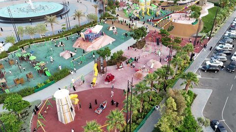 Focus on the agricultural engineering of trees and green plants in tourist areas, the engineering design of roads and streets in Saudi Arabia, famous landmarks to attract tourists on the Jeddah Corniche, and aerial drone photography of Prince Majed Park in Jeddah.