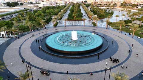 Focus on the agricultural engineering of trees and green plants in tourist areas, the engineering design of roads and streets in Saudi Arabia, famous landmarks to attract tourists on the Jeddah Corniche, and aerial drone photography of Prince Majed Park in Jeddah.