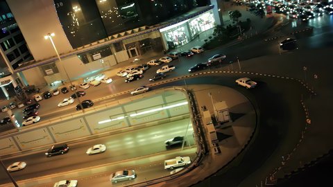 Traffic and transportation at night, aerial drone footage of King Fahd Road in the capital of Saudi Arabia, the growth and development of infrastructure in Riyadh, and the architectural art of towers, residential and commercial buildings.