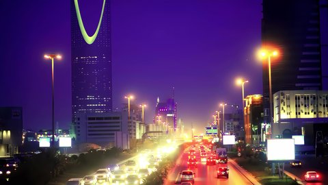 برج المملكة المضاء في الليل، حركة وسائل النقل والمواصلات، تصوير درون جوي لطريق الملك فهد في عاصمة المملكة العربية السعودية، نمو وتطور البنية التحتية في مدينة الرياض، الفن الهندسي المعماري للأبراج والمباني السكنية والتجارية