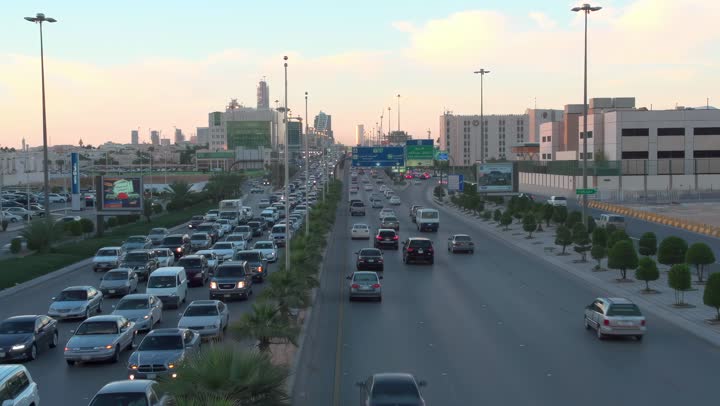 Famous commercial and residential towers during the day, transportation movement, aerial drone photography of King Fahd Road in the capital of the Kingdom of Saudi Arabia, the growth and development of infrastructure in the city of Riyadh, the architectural art of towers and residential and commercial buildings