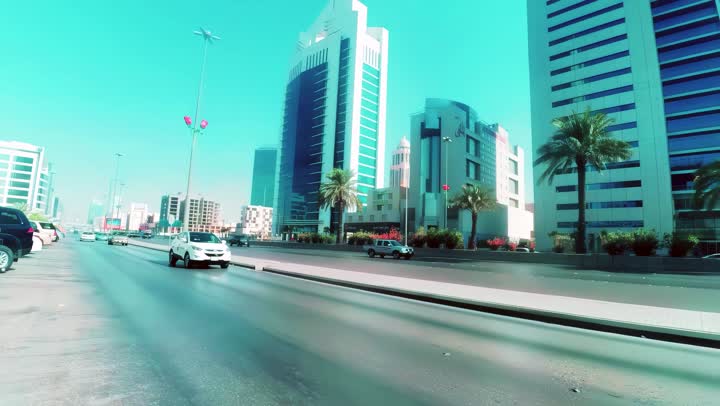 Famous commercial and residential towers during the day, transportation movement, aerial drone photography of King Fahd Road in the capital of the Kingdom of Saudi Arabia, the growth and development of infrastructure in the city of Riyadh, the architectural art of towers and residential and commercial buildings