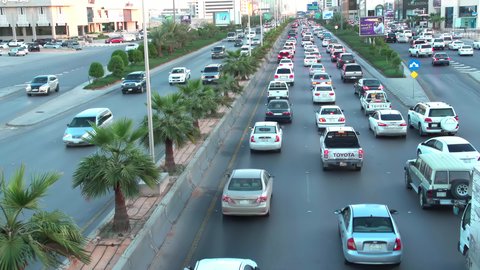 حركة وسائل النقل والمواصلات في النهار، تصوير درون جوي لطريق الملك فهد في عاصمة المملكة العربية السعودية، نمو وتطور البنية التحتية في مدينة الرياض، الفن الهندسي المعماري للأبراج والمباني السكنية والتجارية