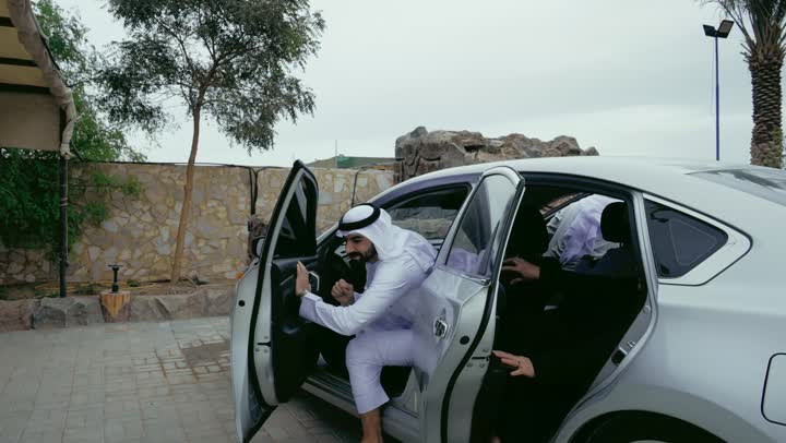Parks and recreational facilities in the United Arab Emirates, strengthening and enhancing family ties, an Emirati Gulf Arab family preparing to spend a fun time in the park during the day, an outdoor family session, a happy family atmosphere