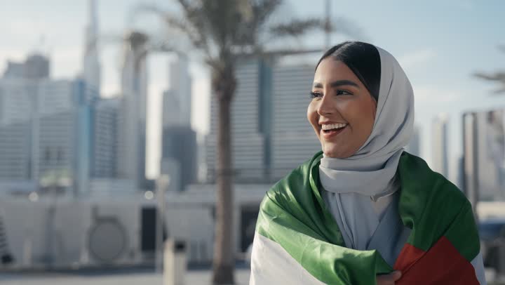 Emirati Gulf Arab woman carrying the UAE flag on her back, celebrating UAE National Day, UAE National Day 51 identity, UAE Independence Day, love of the homeland, UAE National Day, pride and honor