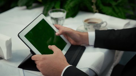 Using a modern and developed technical device, displaying an empty green chroma screen, enjoying coffee siph