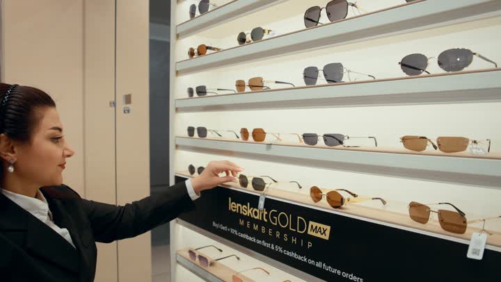 A wide new selection of eyeglasses in a Gulf store, how to choose sunglasses that suit your facial features, buying sun protection glasses, a close-up shot from the side of a Gulf saleswoman displaying sunglasses