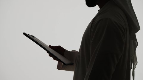 Integrating modern technologies into daily life, completing tasks remotely, online shopping using a tablet, silhouette of an Arab Gulf Emirati man, Emirati jobs and professions, white background