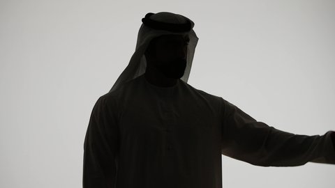 Fitness and health, silhouette of an Arab Gulf Emirati man raising his hand with a clenched fist, muscular strength and display, displaying physical strength, building a healthy body, white background