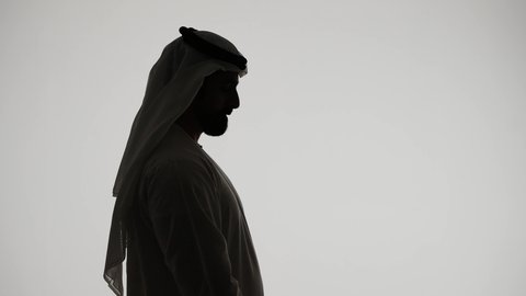 Professional Emirati photographer, taking commemorative photos, silhouette of an Emirati Gulf Arab man holding a high-resolution camera, mastery and professionalism in the photography profession, white background