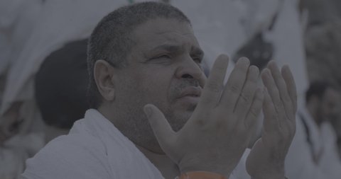 Completing the Hajj rituals, pilgrims standing on Mount Arafat in the Kingdom of Saudi Arabia, a close-up of a pilgrim praying and turning to God Almighty on Mount Arafat, humility and great Islamic feelings of faith, performing the Islamic duties in Mecca.