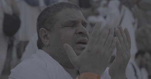 Completing the Hajj rituals, pilgrims standing on Mount Arafat in the Kingdom of Saudi Arabia, a close-up of a pilgrim praying and turning to God Almighty on Mount Arafat, humility and great Islamic feelings of faith, performing the Islamic duties in Mecca.
