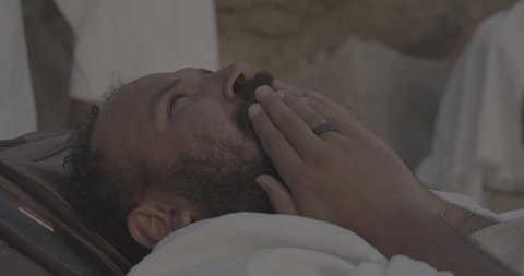 Completing the Hajj rituals, pilgrims standing on Mount Arafat in the Kingdom of Saudi Arabia, a close-up of a pilgrim praying and turning to God Almighty on Mount Arafat, humility and great Islamic feelings of faith, performing the Islamic duties in Mecca.