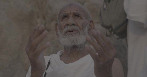 Completing the Hajj rituals, pilgrims standing on Mount Arafat in the Kingdom of Saudi Arabia, a close-up of a pilgrim praying and turning to God Almighty on Mount Arafat, humility and great Islamic feelings of faith, performing the Islamic duties in Mecca.