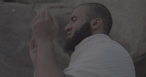 Completing the Hajj rituals, pilgrims standing on Mount Arafat in the Kingdom of Saudi Arabia, a close-up of a pilgrim praying and turning to God Almighty on Mount Arafat, humility and great Islamic feelings of faith, performing the Islamic duties in Mecca.
