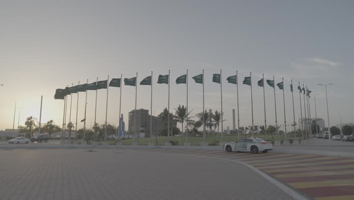 Patriotism and appreciation of national identity, famous tourist attractions in Jeddah, planting plants and palm trees, flags of the Kingdom of Saudi Arabia on the road, celebrating Saudi National Day, September 23