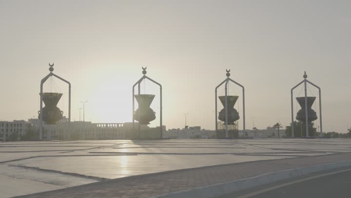 Archaeological excavation in Jeddah, Saudi Arabia, the architectural design of the four large Andalusian lanterns, traffic movement in the roads and streets of the coastal city during the day, famous landmarks of Jeddah