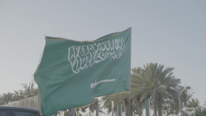 Raising the flag of the Kingdom of Saudi Arabia in Jeddah during the day, celebrating Saudi National Day on September 23, Flag Day on March 11, a famous landmark and place, pride and honor in the flag of the nation