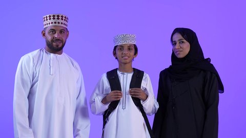Learning in advanced schools in the Sultanate of Oman, preparing to start a new school year, a photo of an Omani Gulf Arab family helping their son get ready to go to school