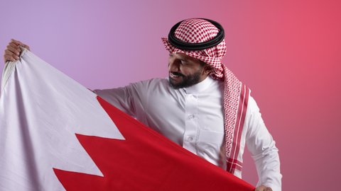 الاحتفال باليوم الوطني القطري 18 ديسمبر، إحياء ذكرى تأسيس الدولة، تصوير لرجل عربي خليجي قطري يحمل علم قطر بايماءات الفخروالاعتزاز، رموز وثقافات وطنية, حب الوطن والانتماء إليه، خلفية ملونه