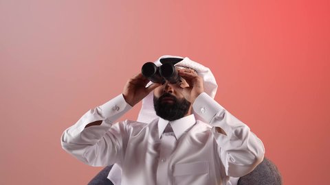 Clarifying and zooming vision, a young Saudi man using binoculars to see distant objects, planning and setting future goals, portrait of a Qatari Gulf Arab man wearing traditional thobe and ghutra sitting on a chair and placing a telescope with zoom lenses on his eyes, colored background