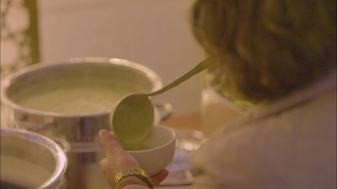 مفهوم الخدمة الذاتية في المطاعم السعودية، اصناف متنوعه من المأكولات والمشروبات، قضاء اوقات ممتعه فى الهواء الطلق ، تصوير مقرب ليد سيدة عربية خليجية سعودية تقوم بسكب الطعام من البوفيه في المطعم