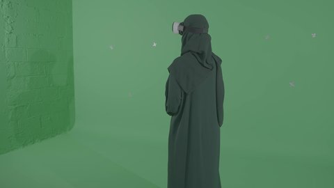Merging the imaginary world with fun and entertainment, raising hands high with expressions of trying to touch something, modern technologies and devices, a portrait from behind of a Saudi Arabian Gulf woman wearing a hijab and virtual reality glasses playing video games, having a good time playing, green background, chroma.