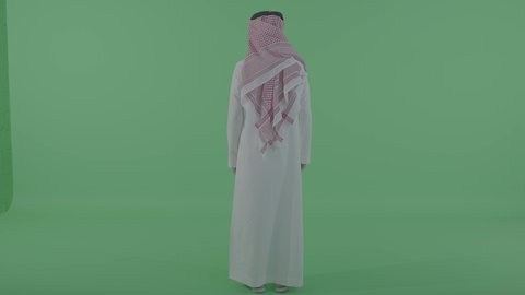 مفهوم الرجولة والأناقة، الاهتمام بالمظهر الخارجي, بورتريه من الخلف لرجل عربي خليجي سعودي يرتدي الثوب التقليدي والشماغ يقف باستقامة و ينظر الى شيء ما فى الاعلي ، الجسم بالطول الكامل ، خلفية خضراء ، كروما