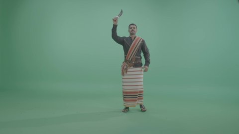 الفعاليات الترفيهية والأنشطة في السعودية، الاحتفال باليوم الوطني السعودي 23 سبتمبر, بورتريه لشاب عربي خليجي سعودي يرتدي الزي الجيزاني يقوم بالرقص الشعبي , ايماءات السعادة و السرور، خلفية خضراء، كروما
