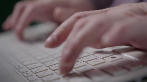 Recruitment in Kuwaiti offices and companies, using modern technologies in administrative work, completing work tasks remotely, integrating advanced technology into daily life, focusing, dedication, and hard work. A close-up of an elderly Saudi Arabian Gulf woman wearing an abaya and hijab sitting on a chair and working on a laptop.
