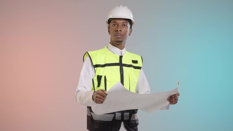 العمل في القطاع الهندسي، مفهوم ادارة المشاريع وتدقيقها، بورتريه لمهندس عربي خليجي سعودي يرتدي الزي التقليدي مع سترة الحمايه والخوذة يحمل مخطط هندسي, خلفيه ملونه