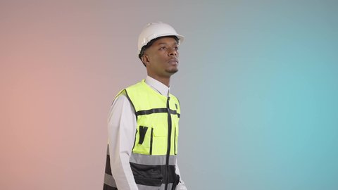 Vision and expanding the field of view, supervising engineering projects, the engineering sector in Saudi Arabia, a portrait of an Arab Gulf Saudi engineer wearing a thobe, helmet, and safety vest looking through binoculars, colorful background.