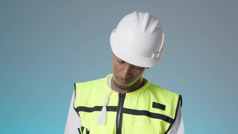 تدوين و تسجيل الملاحظات, كتابة آخر المستجدات حول المشروع، مفهوم الإنشاءات المعمارية والهندسة، مهندس عربي خليجي عماني يرتدي سترة عاكسة و خوذة بيضاء