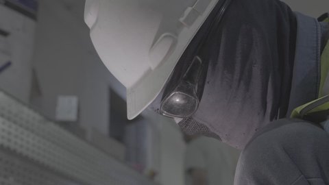 وظيفة ومهنة صناعية شبابية، تجهيز وتوصيل الحديد بمعدات وأدوات خاصة، متابعة سير العمل في ورش الحدادة بمهارة وإتقان، تصوير مقرب لعامل عربي خليجي سعودي يرتدي القفازات للحماية يقوم بصقل الأجزاء المعدنية وتشكيلها