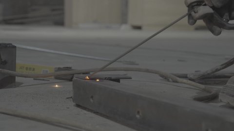 A youth industrial job and profession, preparing and connecting iron with special equipment and tools, skillfully and perfectly following up on the progress of work in blacksmith workshops, a close-up of a Saudi Arabian Gulf worker wearing protective gloves while polishing and shaping metal parts
