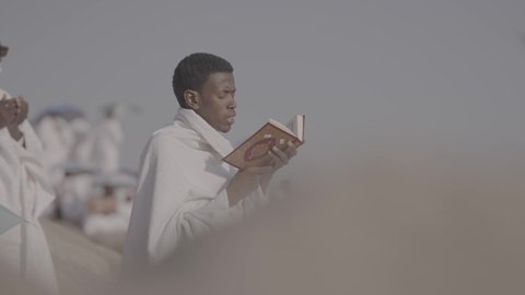 Pilgrims stand on Mount Arafat in the Kingdom of Saudi Arabia, praying and turning to God Almighty on the Mount of Mercy, humility and great Islamic feelings of faith, performing the duties of Islam in Mecca, completing the Hajj rituals