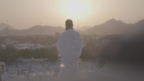 Pilgrims stand on Mount Arafat in the Kingdom of Saudi Arabia, praying and turning to God Almighty on the Mount of Mercy, humility and great Islamic feelings of faith, performing the duties of Islam in Mecca, completing the Hajj rituals