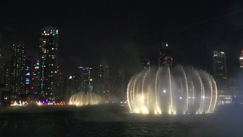 Designs showcasing the distinctive entertainment venues in Dubai, attractions that attract tourists from around the world, the architectural art of building towers and skyscrapers, famous tourist attractions in the United Arab Emirates, and a photograph of the dancing water fountain show in Dubai Mall at night.