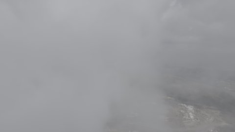 Foggy and cloudy skies in high areas, famous natural tourist attractions in the city of Abha, terrain in mountain peaks and heights, aerial drone photography of the Al-Souda Mountains in the Asir region in the Kingdom of Saudi Arabia, slopes and rugged rocky roads