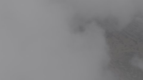 Foggy and cloudy skies in high areas, famous natural tourist attractions in the city of Abha, terrain in mountain peaks and heights, aerial drone photography of the Al-Souda Mountains in the Asir region in the Kingdom of Saudi Arabia, slopes and rugged rocky roads